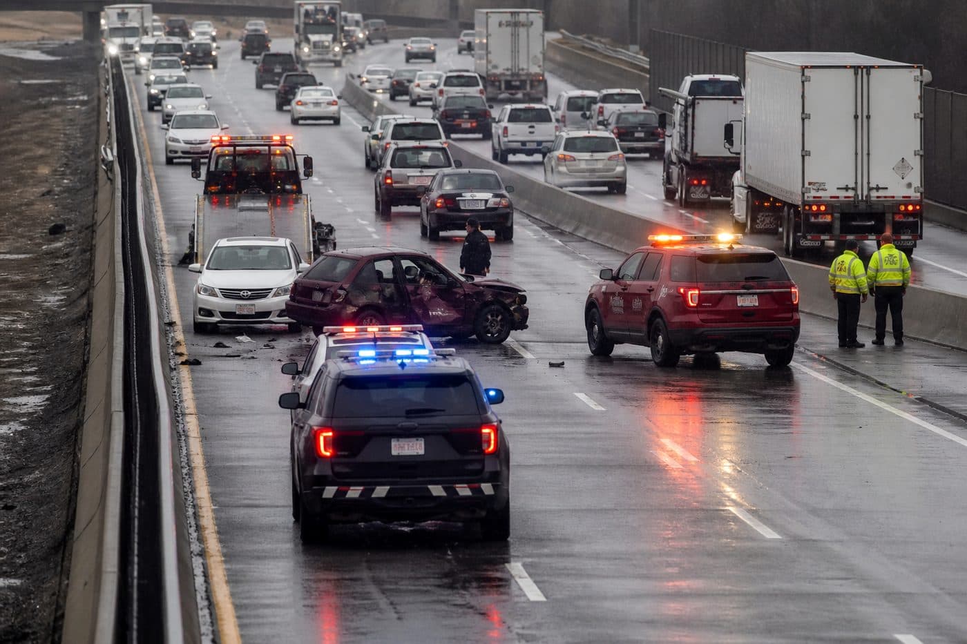 Highway collision with stopped vehicles and hazard lights, editorial context image