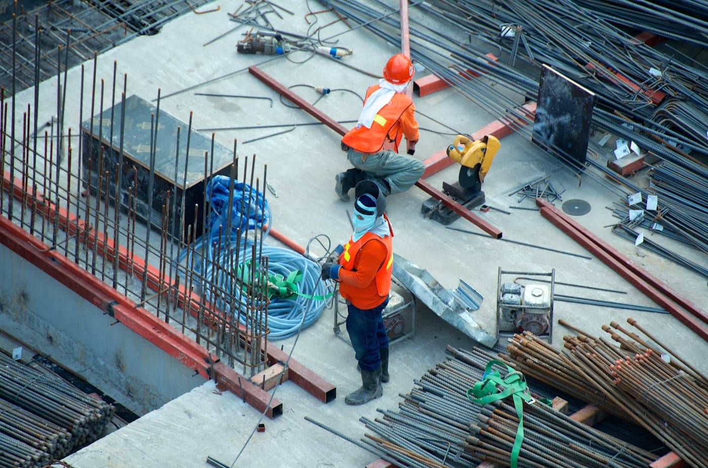 Active construction project with project manager reviewing schedule and progress controls on site, editorial context image