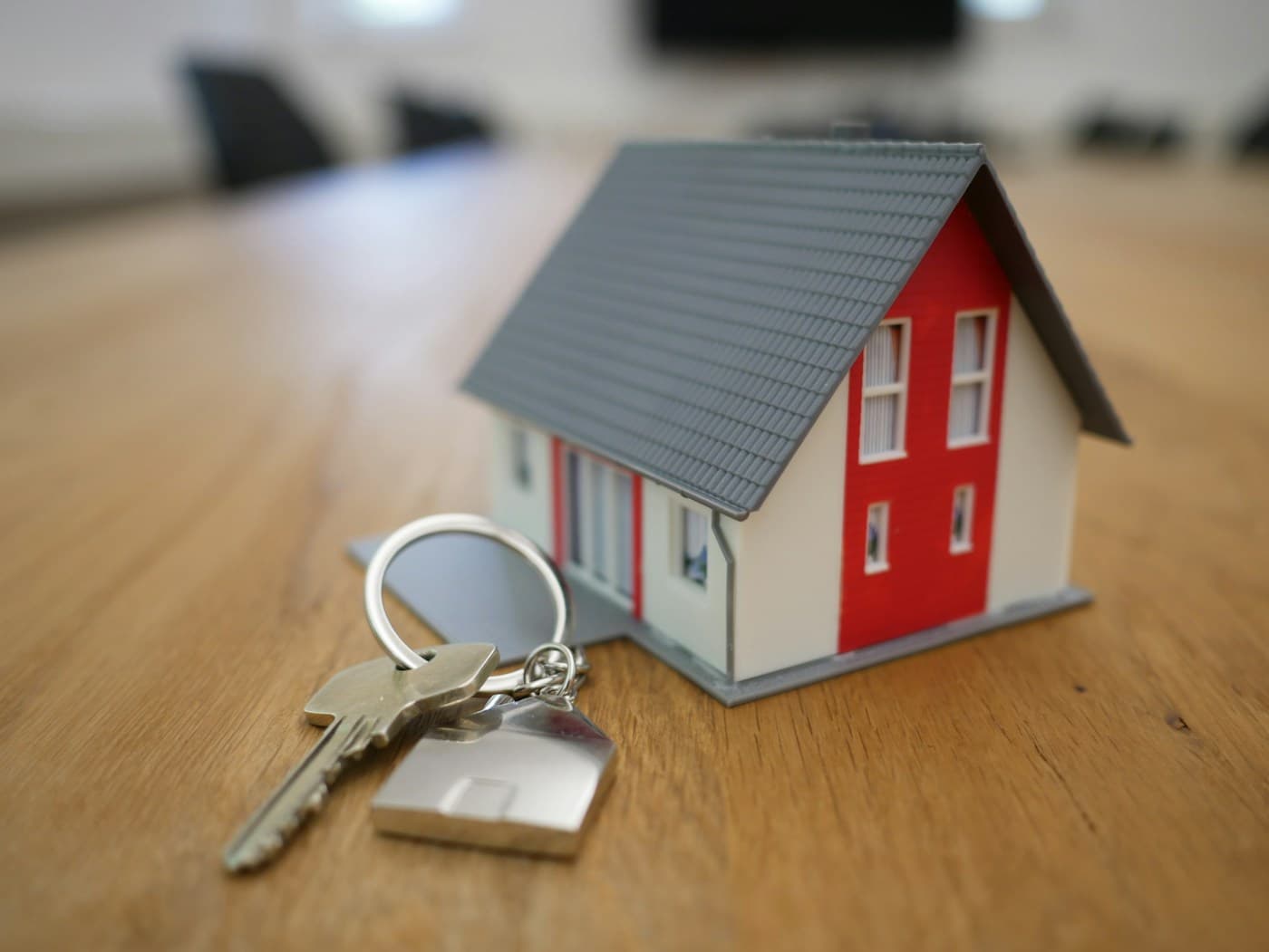 Real estate operations workspace with property listings, buyer requirements and deal pipeline on screen, editorial context image