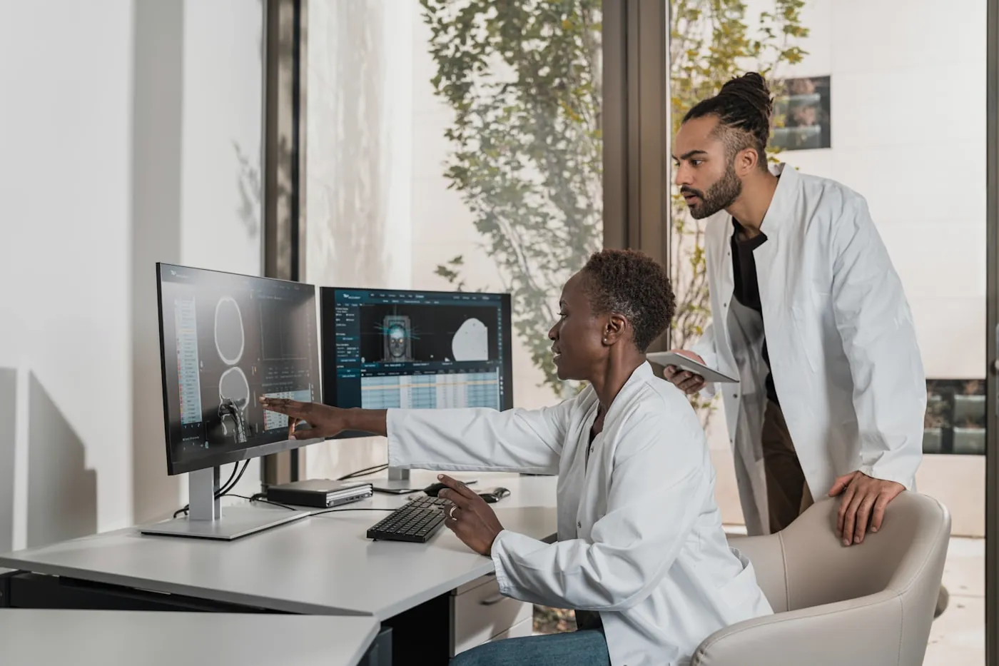 Radiologists reviewing imaging scans at a diagnostic workstation